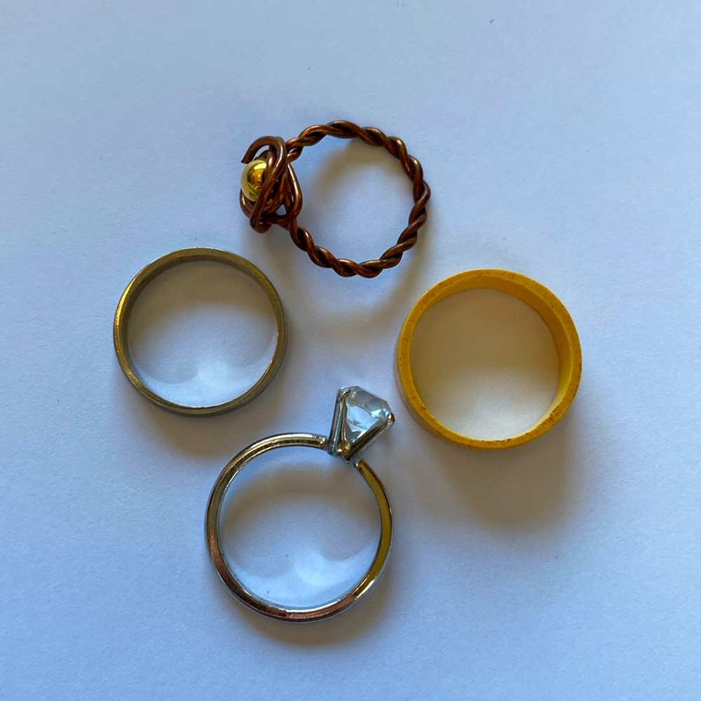 Four rings all different kinds. The diamond is not real. The silver is real!